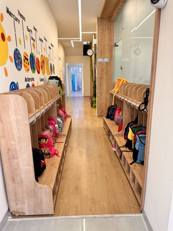 Wooden children's cubbies in the kindergarten hallway