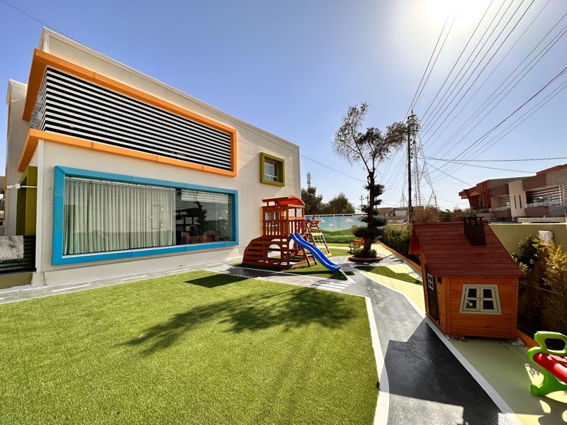 The kindergarten's green garden and playhouses