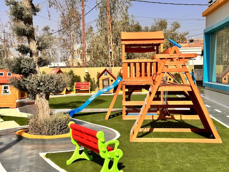 Outdoor playground with climbing frame and slide