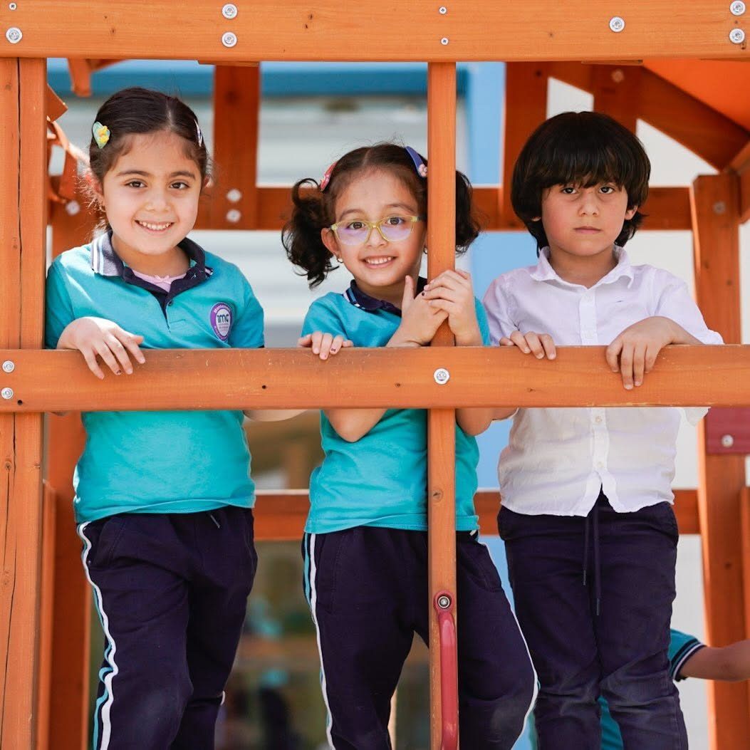 Children playing at the playhouse in the kindergarten garden